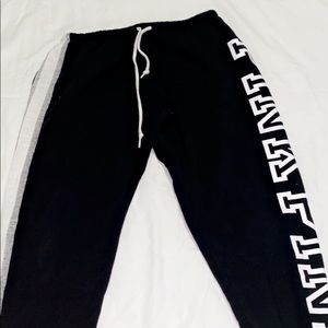black white and grey sweat pants with pink logo